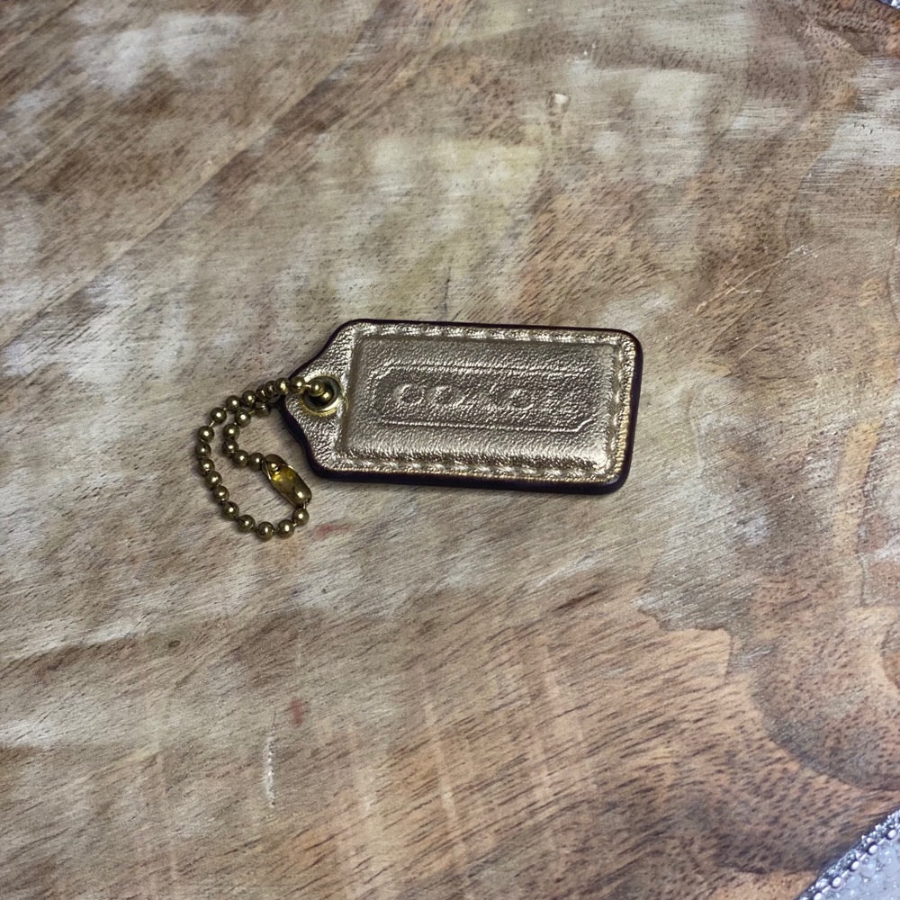 NWOT Mini Bronze Coach Hang Tag